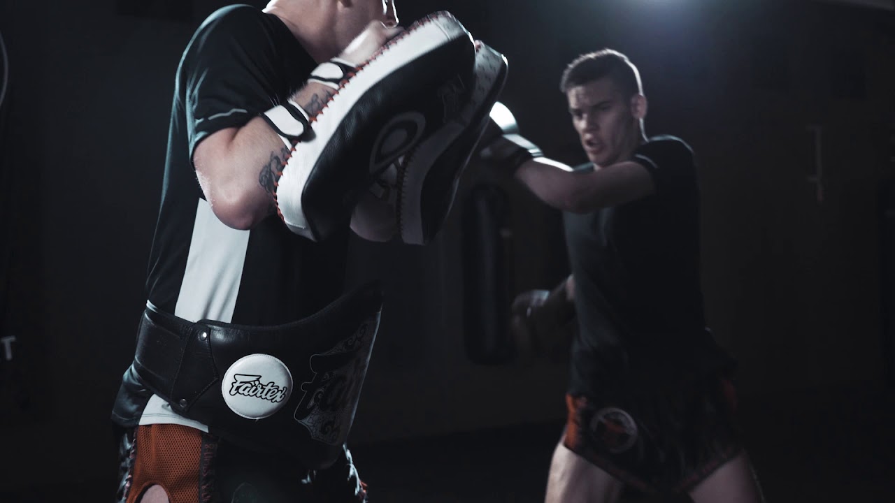 Muay Thai pad work, led by an instructor.